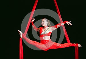 Acrobat performs a difficult trick in the circus.