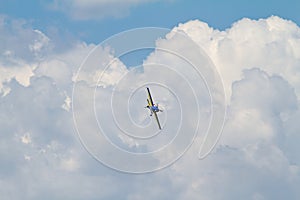 Acrobatic airplane on cloudy sky