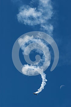 Acrobatic airplane model spiraling towards the ground leaving smoke trail behind