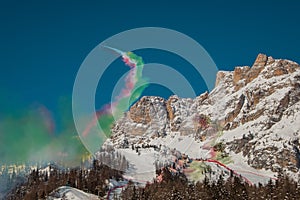 Acrobatic group of Freccia trecolori jet aeroplanes are performing maneouvres in a formation in the italian dolomites close to photo