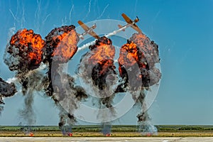 Acrobatic planes flying through smoke