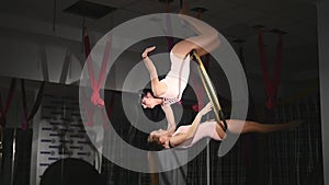 Acrobatic women doing tricks on aerial hoop