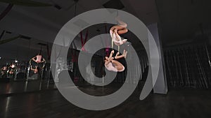 Acrobatic women doing tricks on aerial hoop