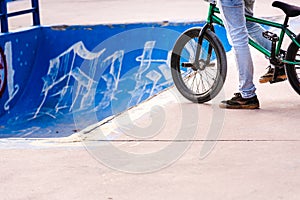 Acrobatics biker waiting his turn to throw a skatepark tube