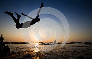 Acrobats jumping into the water in Zanzibar photo