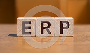 acronym ERP enterprise recource planning text on wooden blocks isolated on yellow background. Business software concept