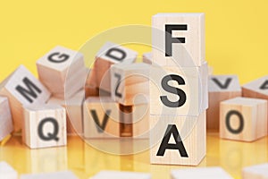 acronym FSA from wooden blocks with letters, concept