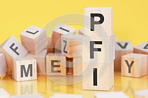 Acronym PFI from wooden blocks with letters, concept