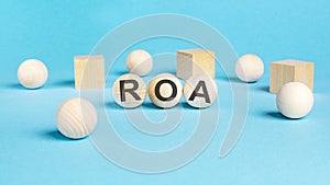 acronym roa on wooden balls, bright blue background
