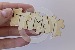 The acronym TMI, which stands for Too Much Information. The letters written on the puzzles. photo