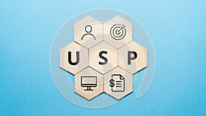 Acronym USP or Unique Selling Proposition. Abstract icons and text on wooden forms