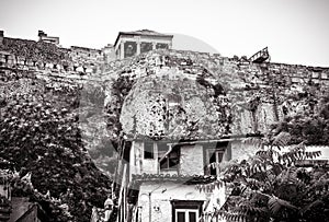 Acropolis of Athens and old houses in Plaka district, Greece. Vintage view of ancient street in Athens city center in black and