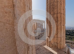 On Acropolis hill, view between columns to the small Ionian style Athena Nike victorious ancient temple