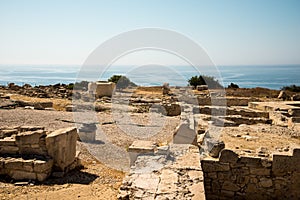 Acropolis ruins and a giant stone vase with Akrotiri bay in background, Cyprus