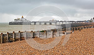 Across the damp empty beach and rows of groynes to the pier at Eastbourne in October