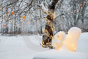 Acrylic artificial squirrel figurine illuminated as Christmas decoration outdoors in home garden, led party lights.