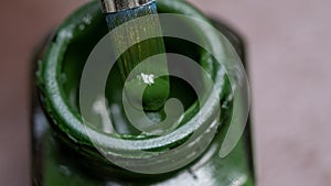 Acrylic Dark Green paint bottle and paintbrush