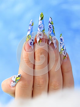 Acrylic flowers on women's nails.