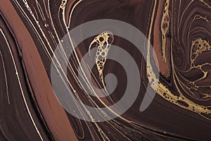 Acrylic Fluid Art. Abstract Golden curl and lines on brown waves. Art Deco marbling background or texture