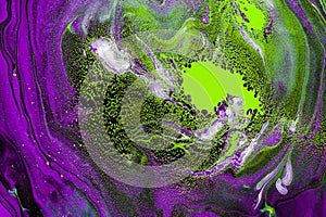 Acrylic Fluid Art. Violet waves and poisonous green spots curls. Abstract swirling background or texture