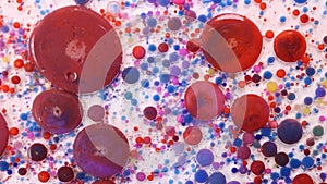 Acrylic paint balls abstract texture. Bright colors fluid, flowing wallpaper design. Purple, blue, pink and yellow