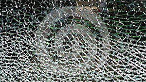 The act of malicious hooliganism. Broken glass wall. photo