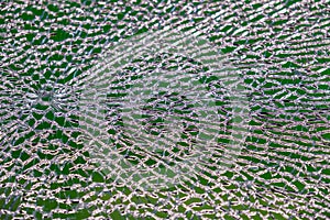The act of malicious hooliganism. Broken glass wall of the new pavilion of the metro station. Abstract background.