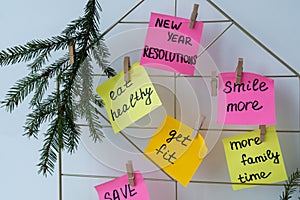 Action board new year's resolutions on colorful sticky notes. Making promises for new year, setting goals. Dream