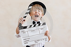 Action, camera, motor! Child holding clapperboard