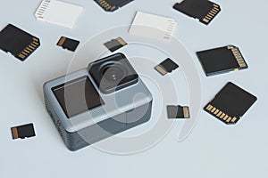 Action camera and SD and MicroSD memory cards. Background from gadgets and digital devices