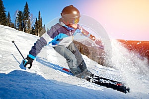 Action camera skier skiing downhill in high mountains during sunny day