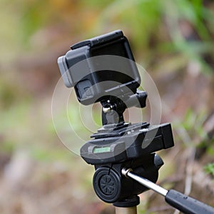 Action camera stands on a small tripod with a water level.