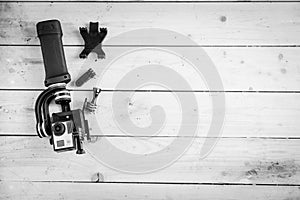 Action camera on the wooden table with a stabilizer