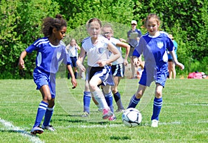 The action is fast in this girls soccer game