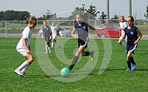 A young soccer player displays her ball control.