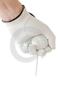 Action of golfer hand in white glove and the golf ball with tee