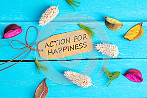 Action for happiness text on paper tag