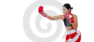 In action, motion. Young girl, professional boxer practicing in boxing gloves isolated on white studio background