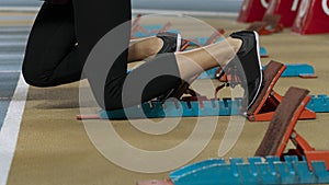 Action packed image of a female athlete leaving the starting blocks