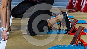 Action packed image of a female athlete leaving the starting blocks