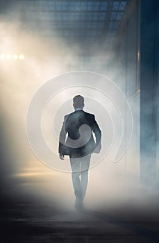 action packet thriller of a mysterious businessman in a foggy alley at night.