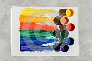 Action painting. Abstract Hand-painted rainbow art background. Multicolored paint strokes and brush