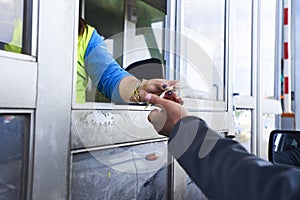 The action of a person paying at a toll.