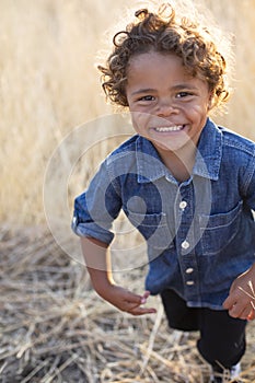 Action photo of a Smiling and active little African American little boy