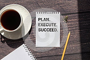 Action Plan Plan, Execute, Succed writing on notebook