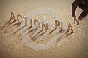 Action plan wood word on corkboard