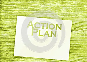 Action plan words, paper signs of dollar on wooden table. Business concept