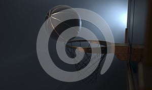 An action shot of a black and gold basketball teetering on the rim of a regular basketball hoop