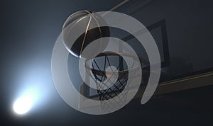 An action shot of a black and gold basketball teetering on the rim of a regular basketball hoop photo