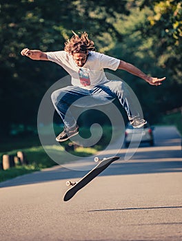 Action shot of a skateboarder skating, doing tricks and jumping